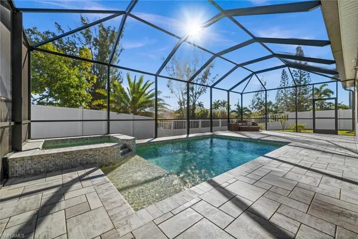 Heated saltwater pool with tanning shelf and spa