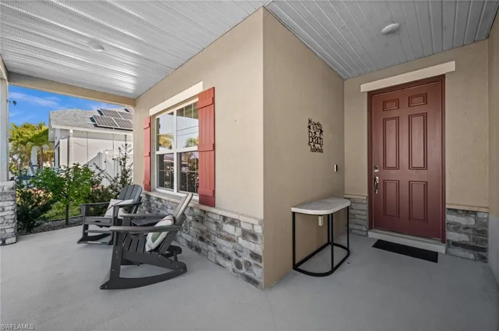 Welcoming under-truss front porch seating