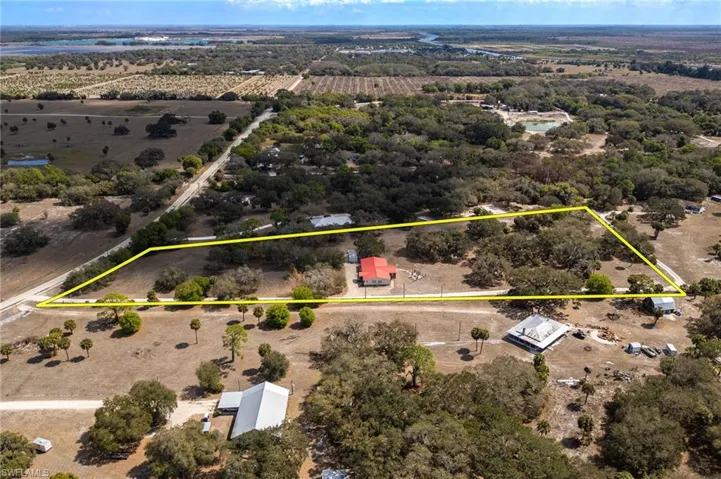 Aerial view of sparsely populated area with property parcel outlined