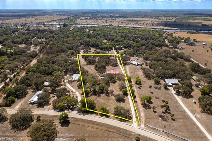 Aerial view of property and surrounding area featuring property boundaries highlighted
