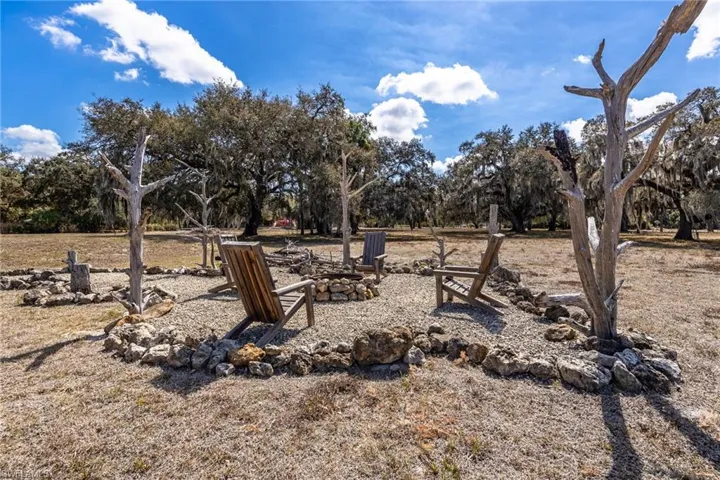 View of yard with an outdoor fire pit