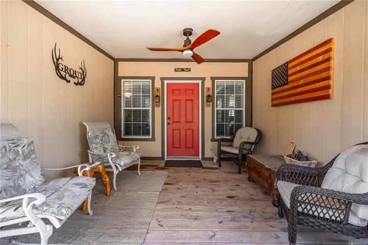 Entrance to property featuring ceiling fan
