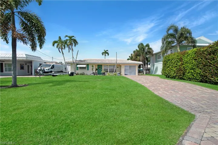 Single story home featuring a front lawn