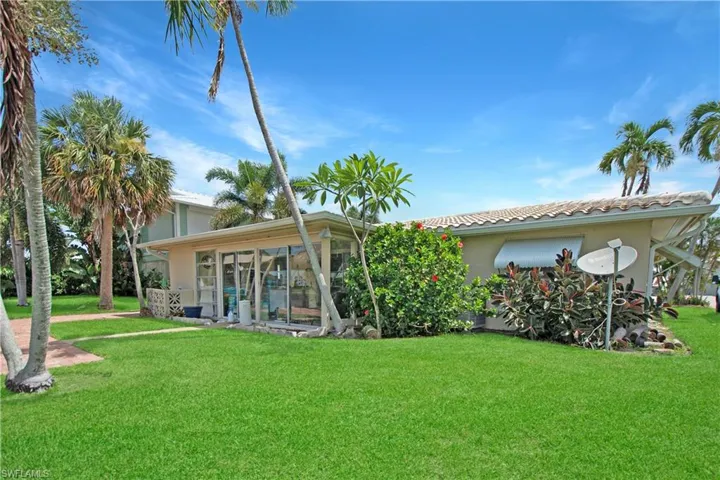 Back of property featuring a yard