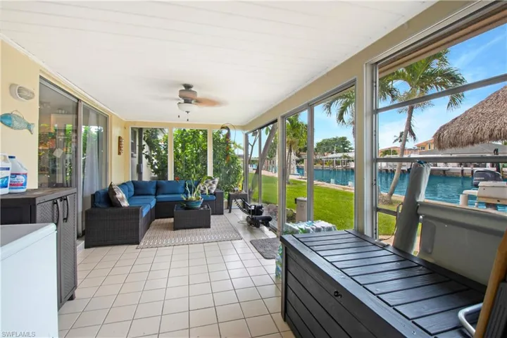Sunroom / solarium featuring plenty of natural light, a water view, and ceiling fan