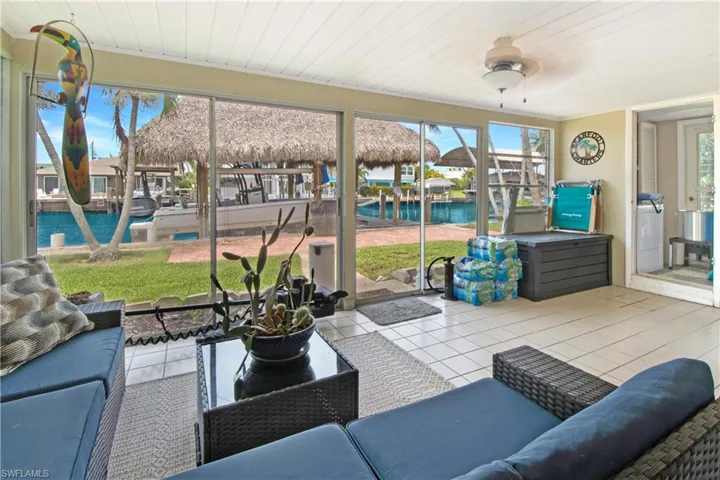 Sunroom / solarium with a water view and ceiling fan