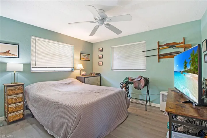 Bedroom with hardwood / wood-style flooring and ceiling fan