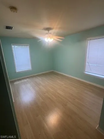 Empty room featuring wood finished floors and a smoke detector