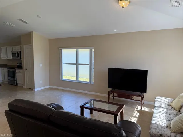 Living room with light tile patterned flooring