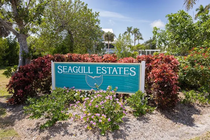 "Seagull Estates" community signage with tropical landscaping