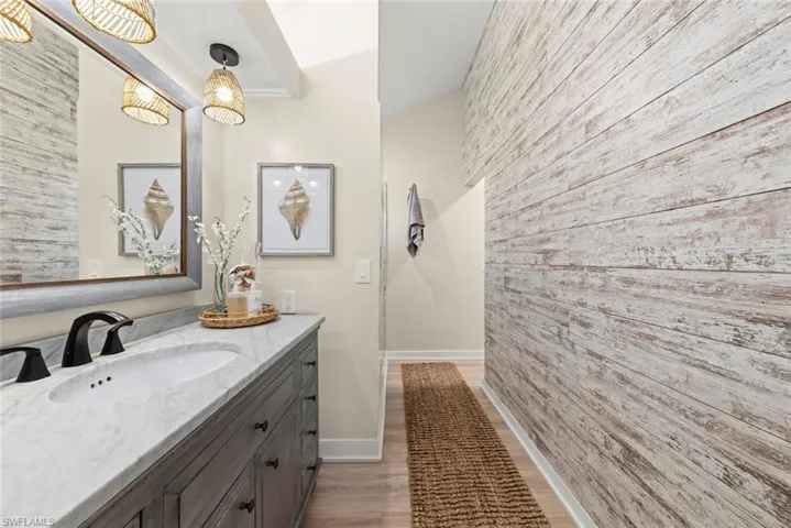 Vanity featuring a stone countertop with an undermount sink and matte black faucet