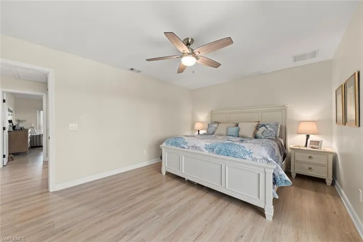 Spacious room featuring light wood-finish flooring and neutral wall tones