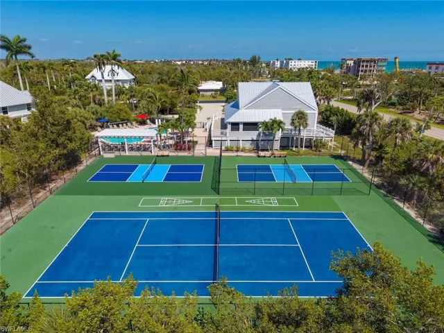 Resort-style recreational facilities featuring two full-size tennis courts, two pickleball courts, and a separate swimming pool area with lounge seating
