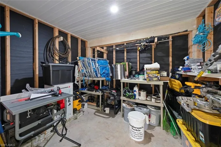 Utility space with exposed wooden wall studs and dark wall sheathing