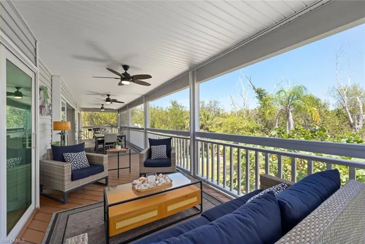 Expansive screened-in porch with wood-finish flooring