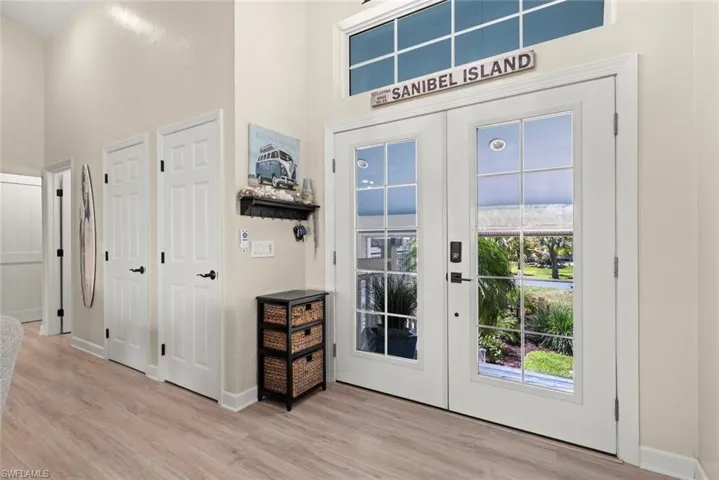 Double French doors with divided lites and transom window