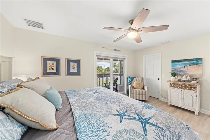 Light-toned wood-finish flooring complements the room's neutral wall color