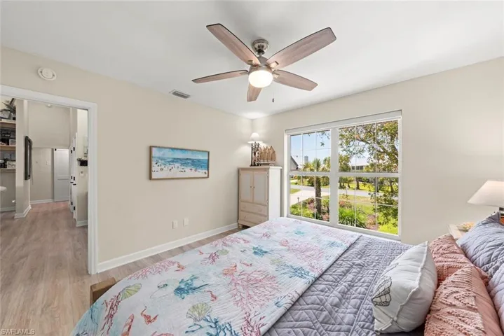 Interior room featuring light wood-finish flooring, light-toned wall paint, and white trim