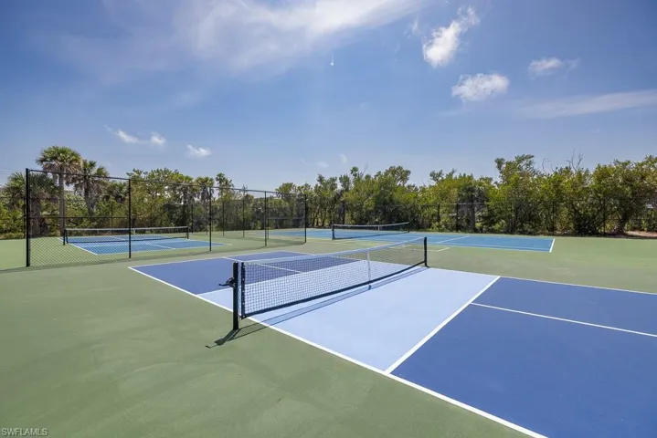 Multiple outdoor courts with green, dark blue, and light blue surfaces