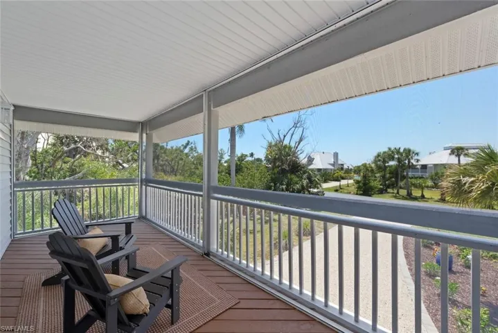 Screened-in porch featuring wood-finish flooring, a white slatted ceiling, and an open-air railing system