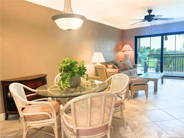 Dining area featuring ornamental molding, ceiling fan, and light tile patterned flooring