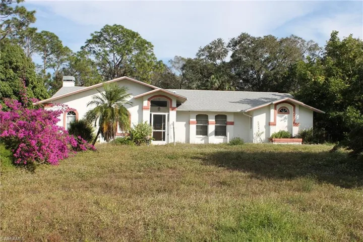 Single story home with a front lawn