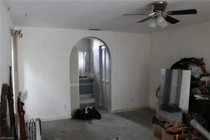 Unfurnished living room with ceiling fan