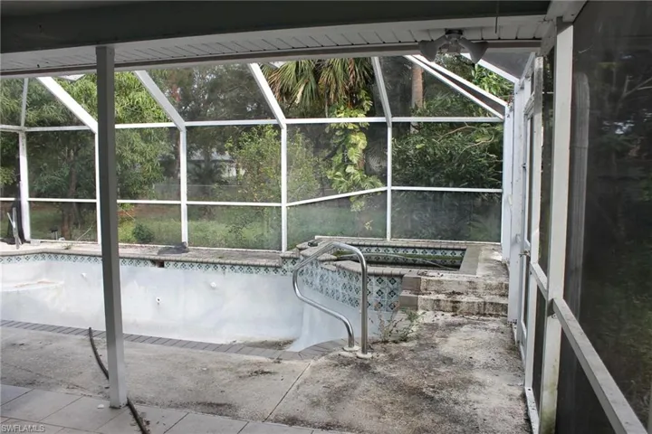 View of swimming pool with screened enclosure