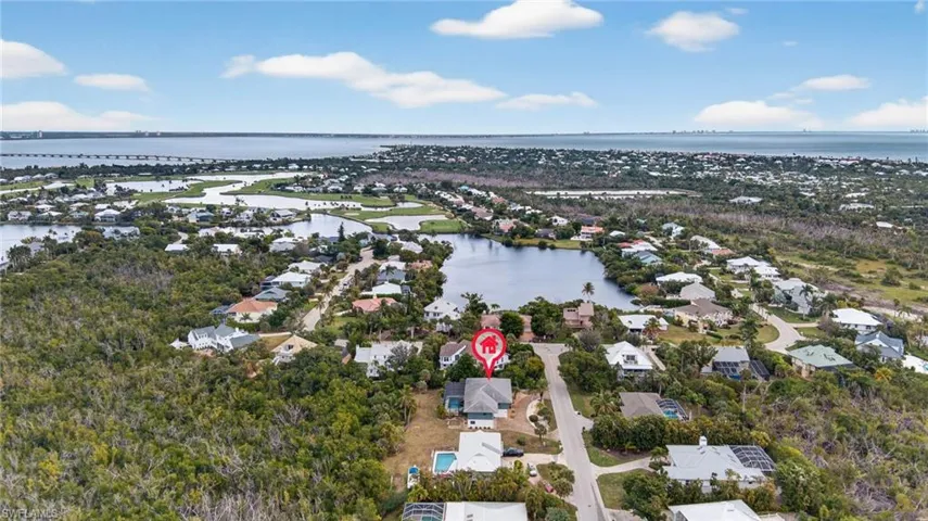 Aerial view of residential area featuring a large body of water