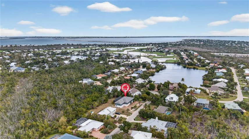 Aerial perspective of suburban area with a nearby body of water