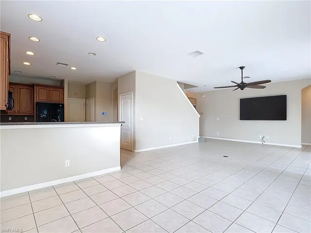 Unfurnished living room featuring recessed lighting, light tile patterned floors, and a ceiling fan