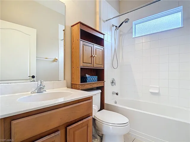 Full bathroom featuring bathing tub / shower combination, vanity, and light tile patterned floors
