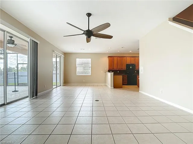 Unfurnished living room featuring light tile patterned floors, ceiling fan, and recessed lighting