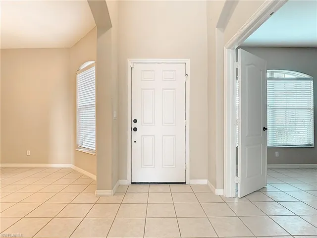 Entryway with light tile patterned floors and plenty of natural light