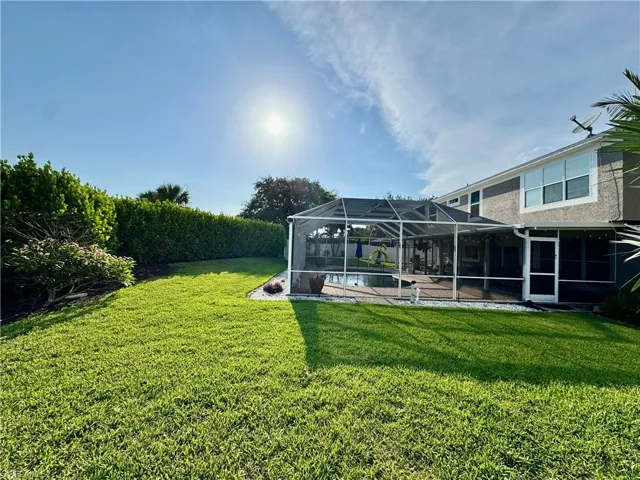 View of grassy yard featuring a lanai