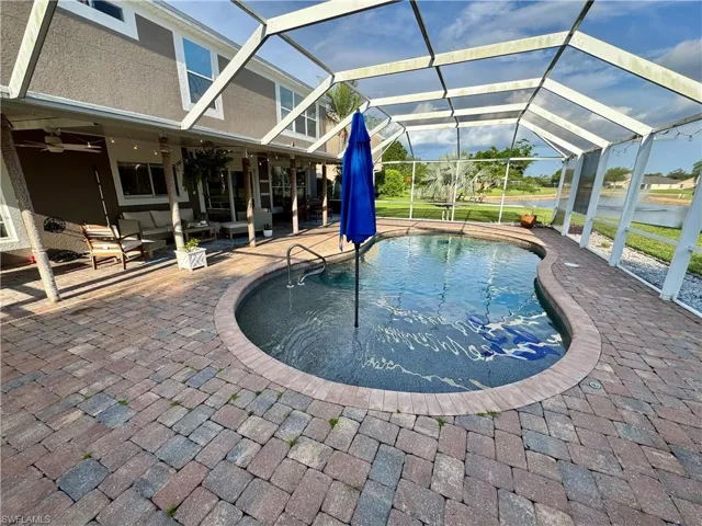 Swimming pool with outdoor lounge area, a patio area, a ceiling fan, and a lanai