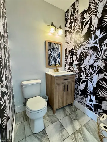 Bathroom with vanity and marble look tile flooring