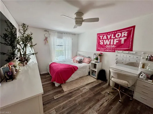 Bedroom with dark wood-style floors and a ceiling fan