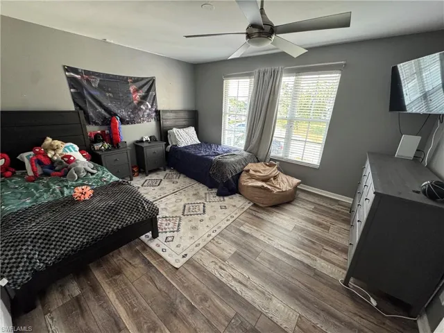 Bedroom with wood finished floors and a ceiling fan