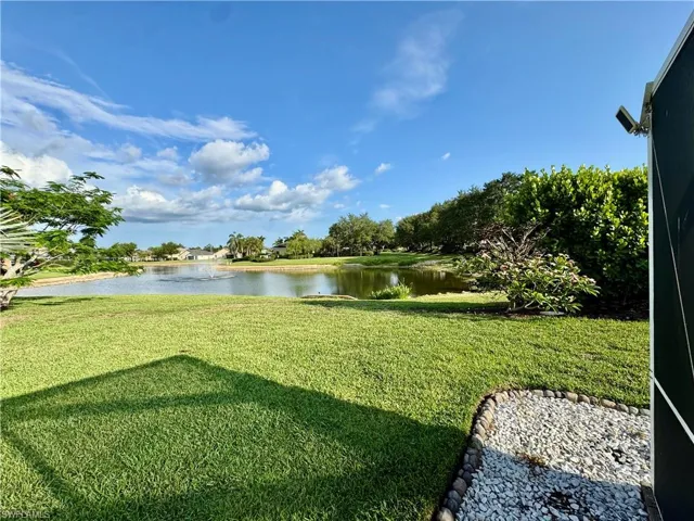 View of grassy yard with a water view