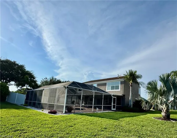 Back of property featuring glass enclosure