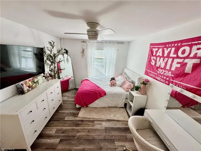 Bedroom featuring dark wood finished floors and a ceiling fan