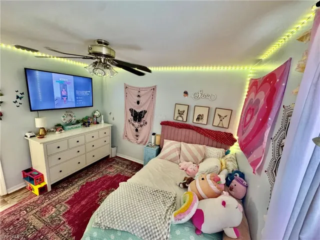 Bedroom with a ceiling fan and baseboards