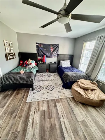 Bedroom with wood finished floors and a ceiling fan