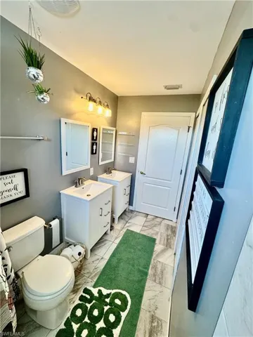 Bathroom with marble look tiles and vanity