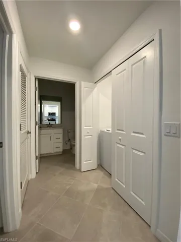 Corridor with light tile patterned floors