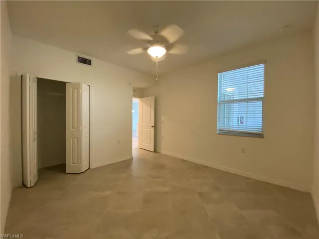 Unfurnished bedroom featuring ceiling fan and a closet