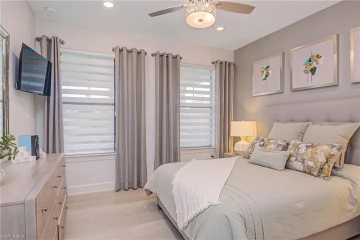 Bedroom featuring ceiling fan and light hardwood / wood-style flooring