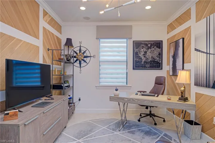 Office featuring wooden walls and ornamental molding