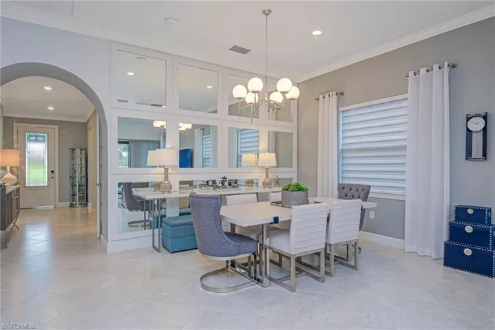 Dining room featuring ornamental molding and a notable chandelier